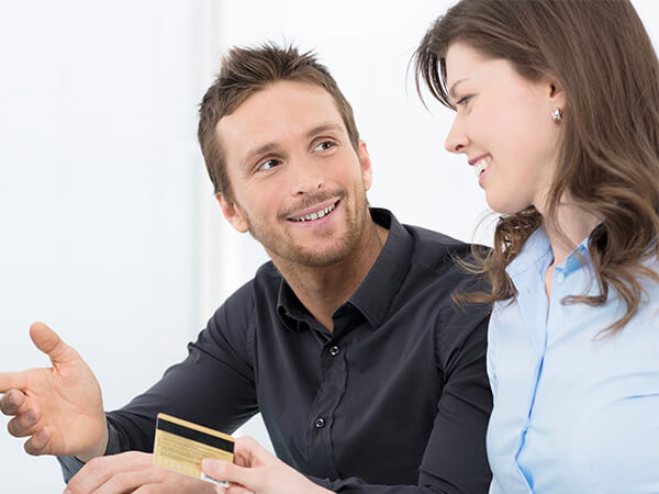 A young couple paying with their credit card 