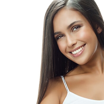 A young woman with long hair smiling